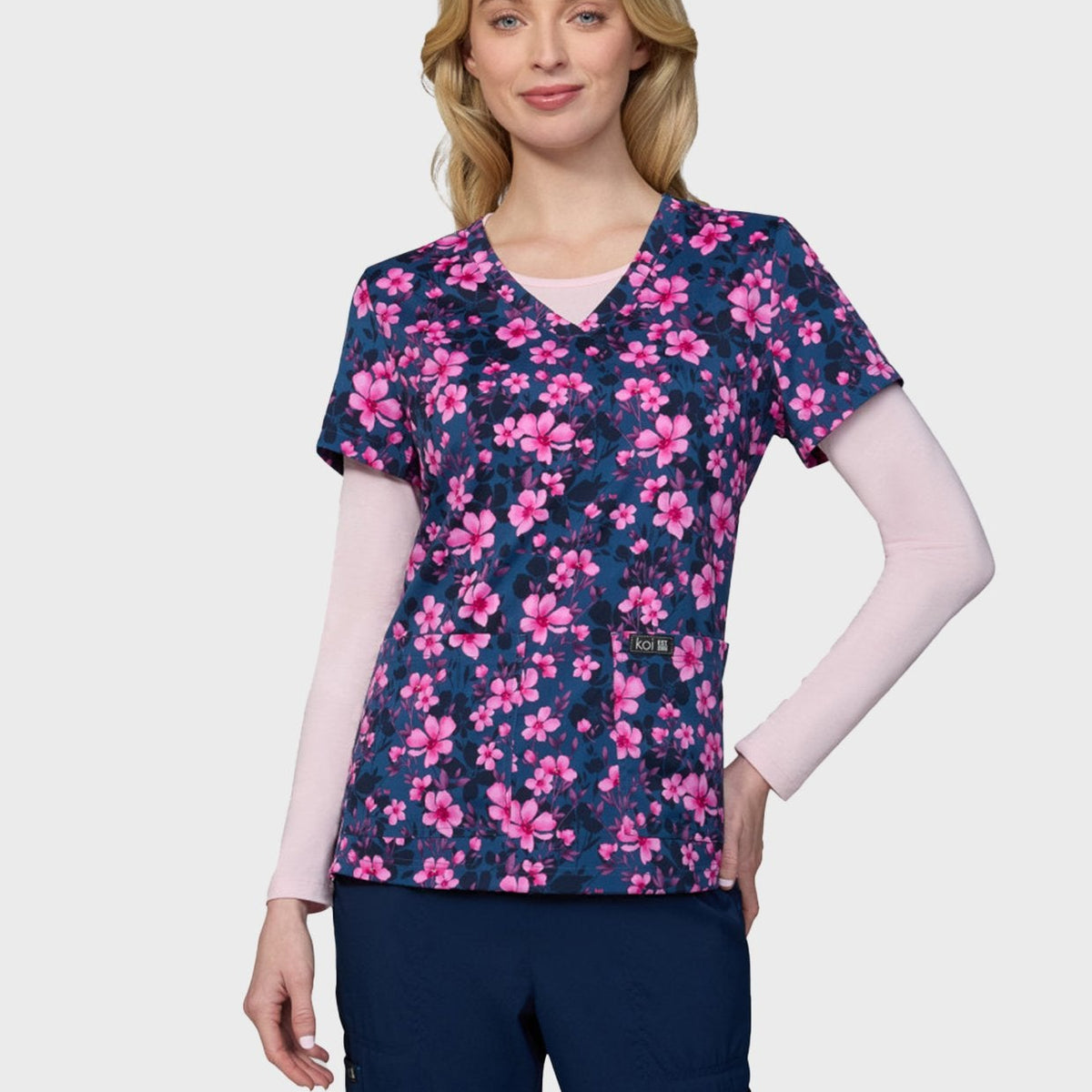 Woman wearing the Petal and Bloom printed scrub top