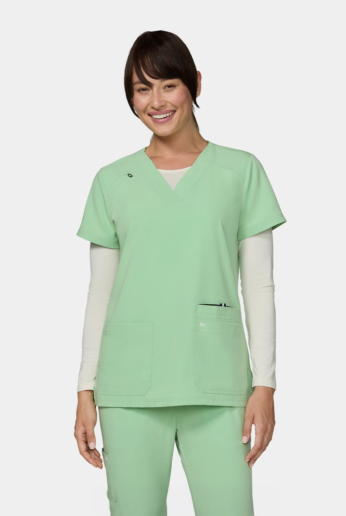 Women's Koi Next Gen Hustle and Heart Scrub Top in Pistachio