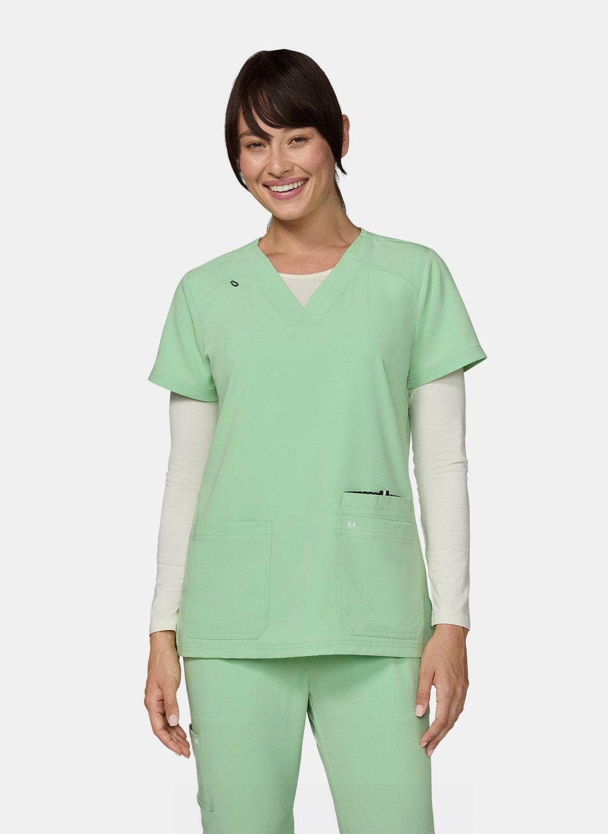 Women's Koi Next Gen Hustle and Heart Scrub Top in Pistachio