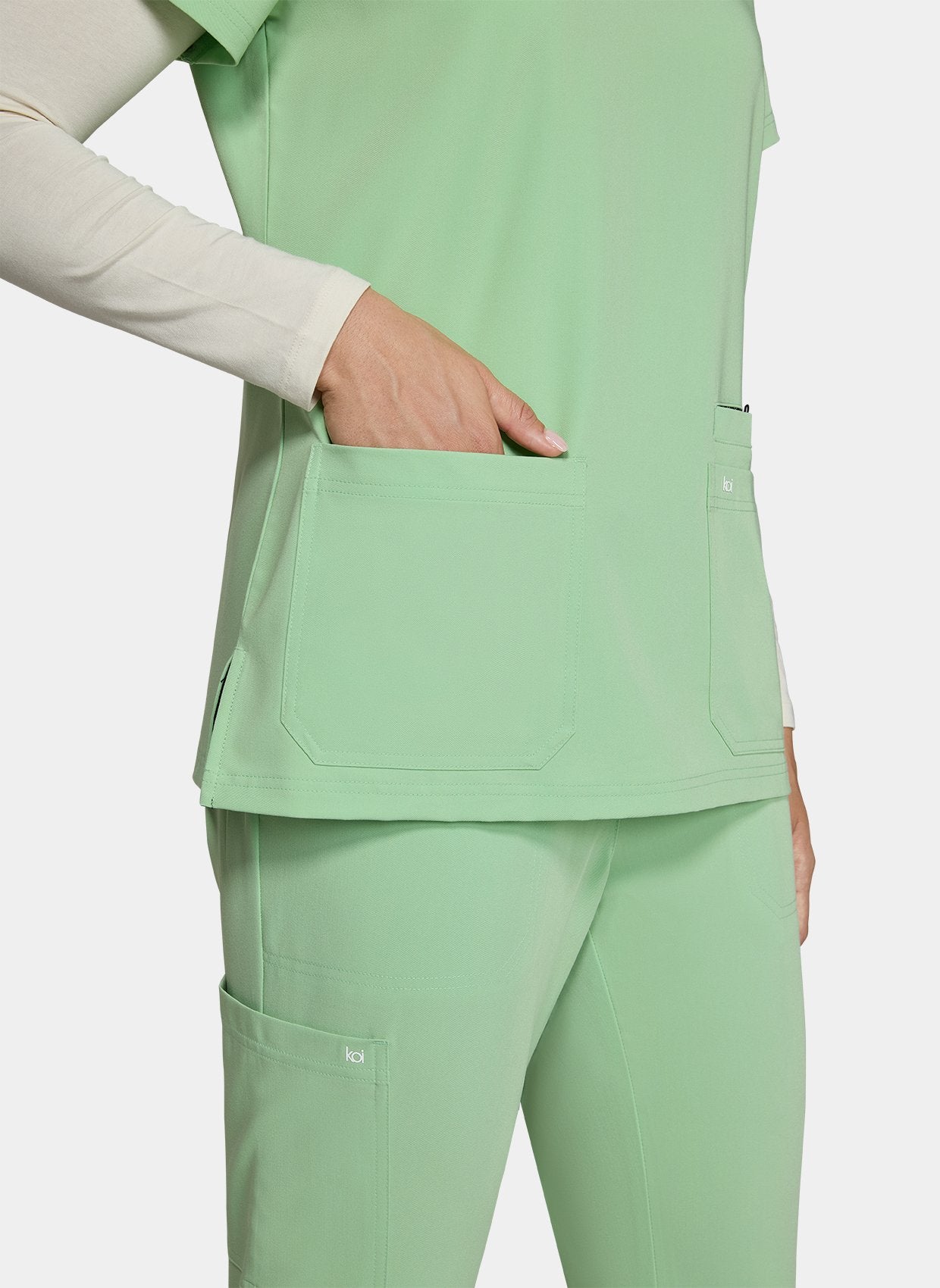 Women's Koi Next Gen Hustle and Heart Scrub Top in Pistachio